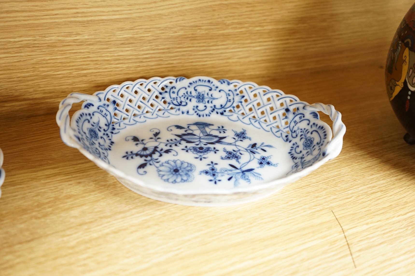 A ‘Meissen’ blue onion pattern dessert service comprising nine plates and two oval twin handled dishes, 24cm wide
